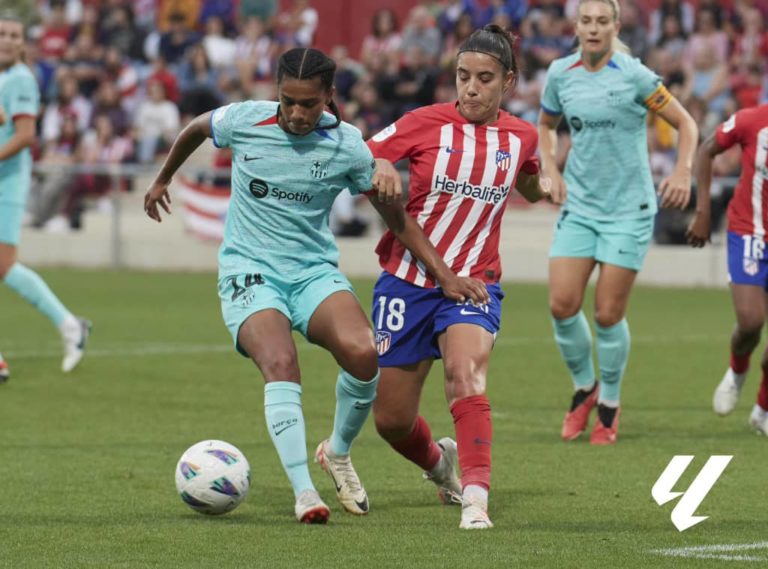 Barcelona Femeni in action against Atletico Madrid